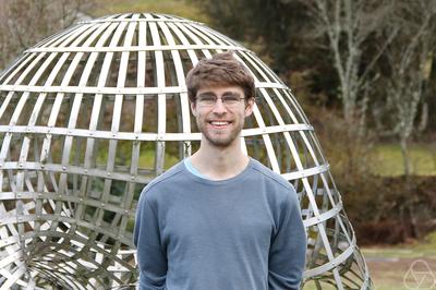 Michael Lindsey in front of the Boy surface sculpture in Oberwolfach